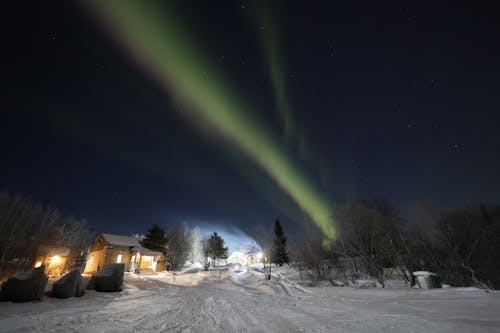 Beautiful Aurora Over Snow Covered Ground 