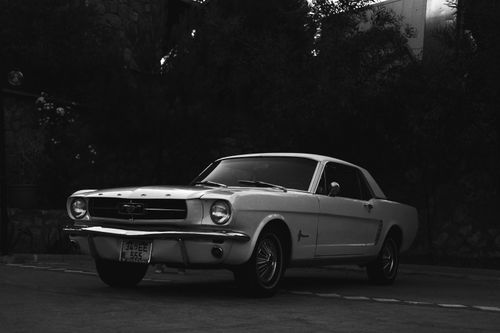 Free Classic Ford Mustang parked outside in grayscale image. Stock Photo