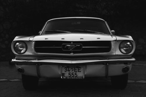 Free Front view of a vintage Ford Mustang in monochrome highlighting its classic design. Stock Photo