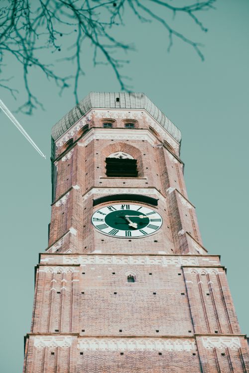 Free Striking low angle view of Munich's historic clock tower on a clear day, showcasing architectural details. Stock Photo