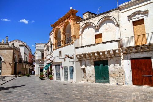 Free Historic buildings line a sunny street in a picturesque Italian town center. Stock Photo