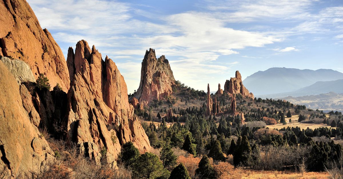 Dramatic red rock formations at Garden of the Gods, Colorado Springs under a bright blue sky.