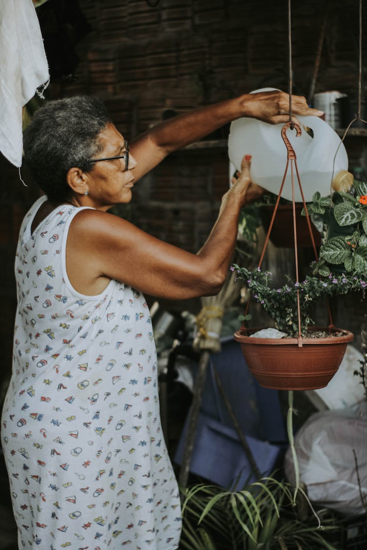 Woman Watering Houseplants