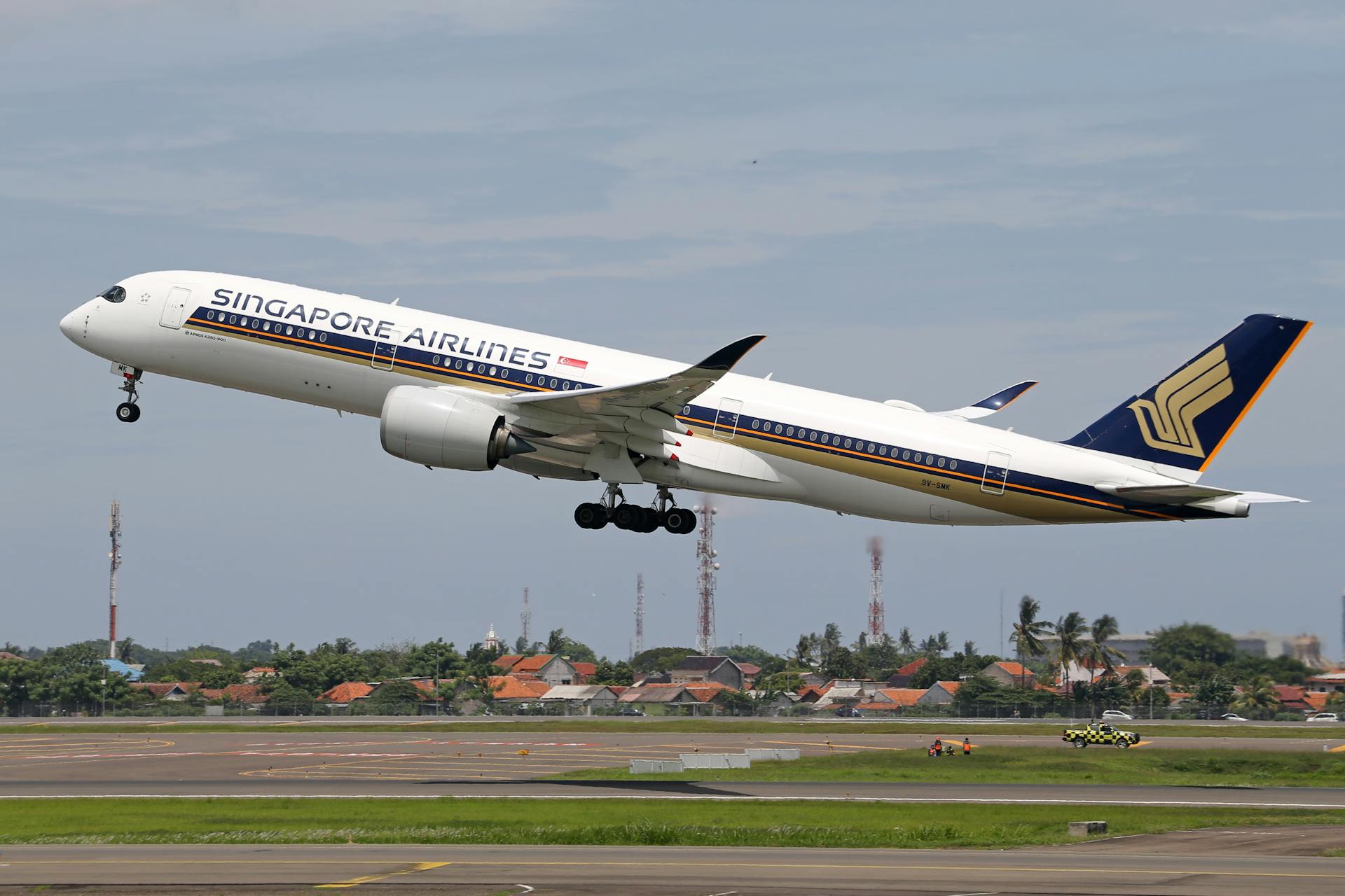 Singapore Airlines Airbus A350 taking off from an airport runway, showcasing air travel and transportation.