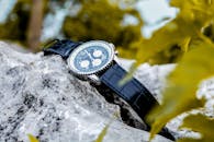 Selective Focus Photography of Chronograph Watch on Rock