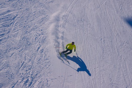 Aerial shot of a skier navigating a snowy slope in Kars, Turkey, showcasing winter sports adventure.