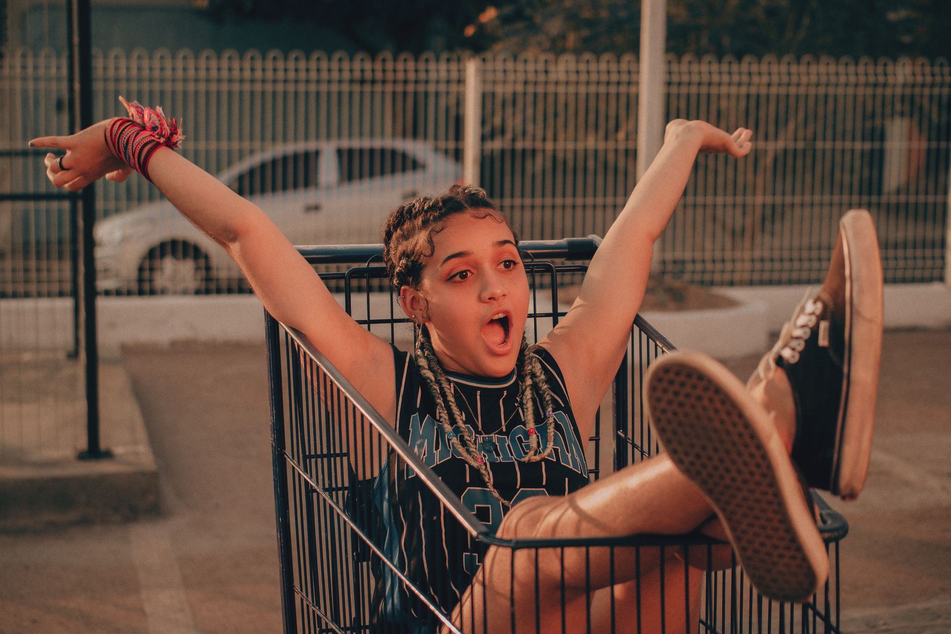 Teenager having fun in a shopping cart, showcasing youthful mischief and playful energy.