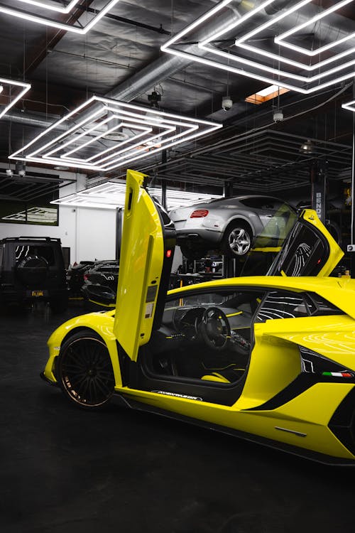 A Yellow Sports Car Parked Under Led Lights