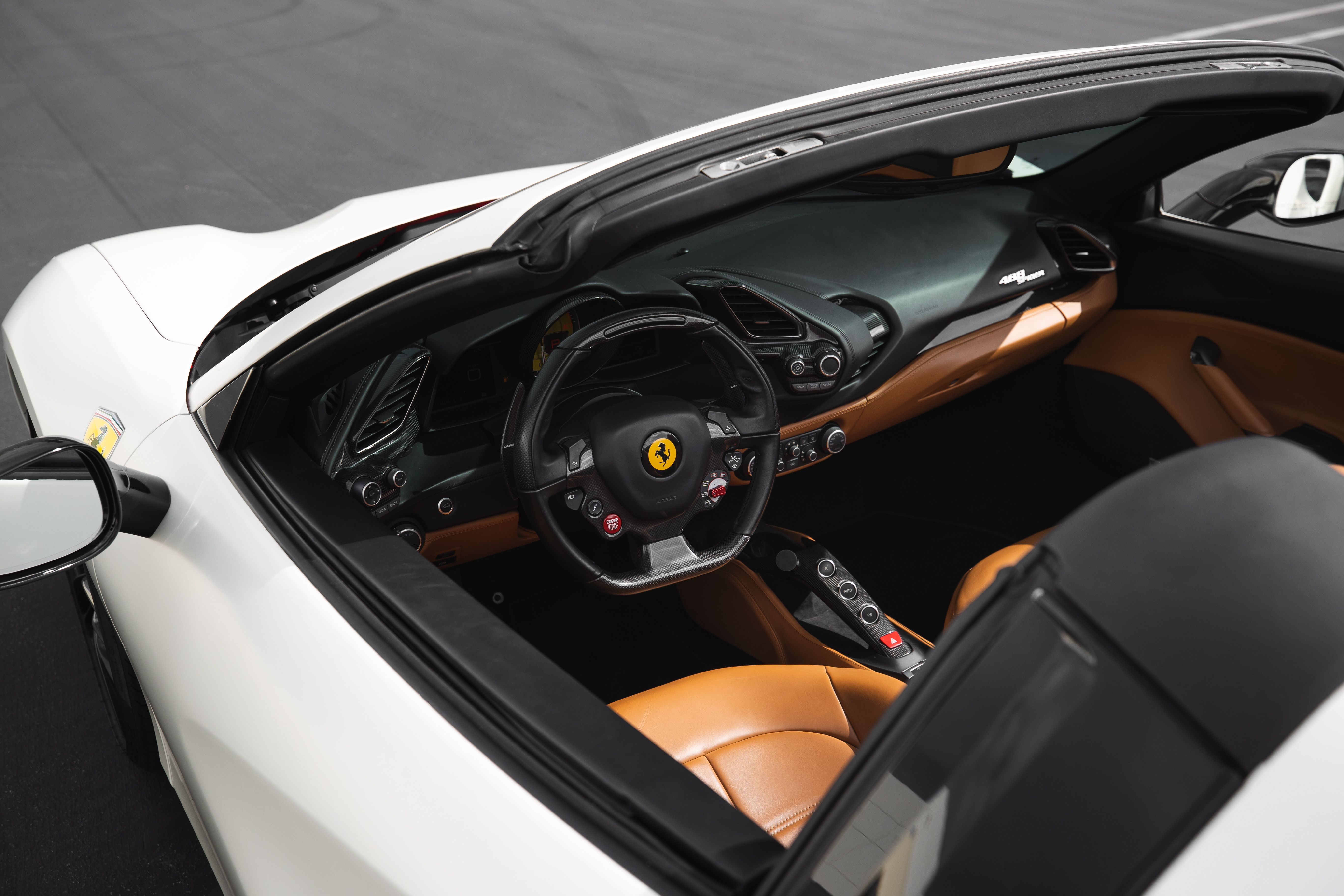 Explore the sleek design and luxury interior of a Ferrari convertible, ideal for automotive enthusiasts.