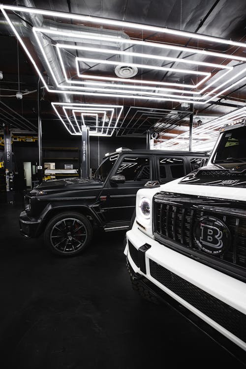 A Black and White Jeep Parked Under Led Lights 