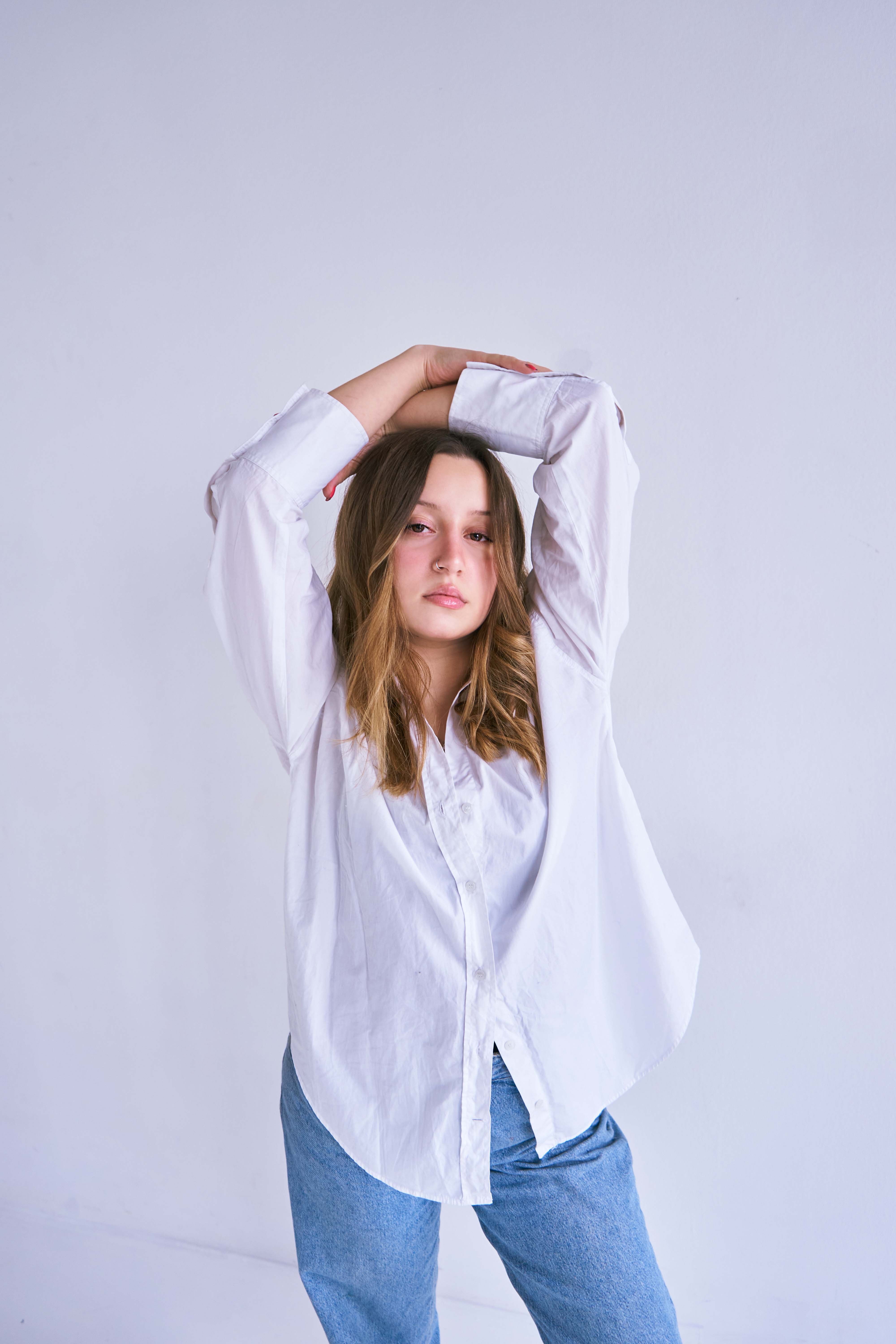 A Woman in White Long Sleeve Shirt Looking at the Camera · Free Stock Photo