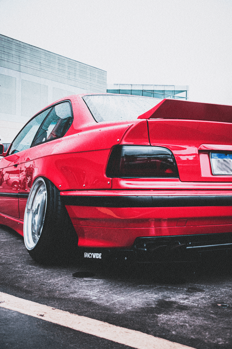 A Red Customized Sports Car With Tilted Wheels