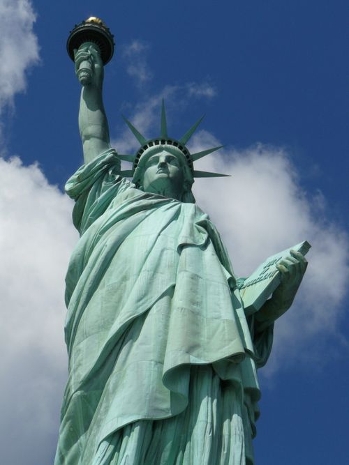 Free Iconic Statue of Liberty against a clear blue sky in New York City. Stock Photo