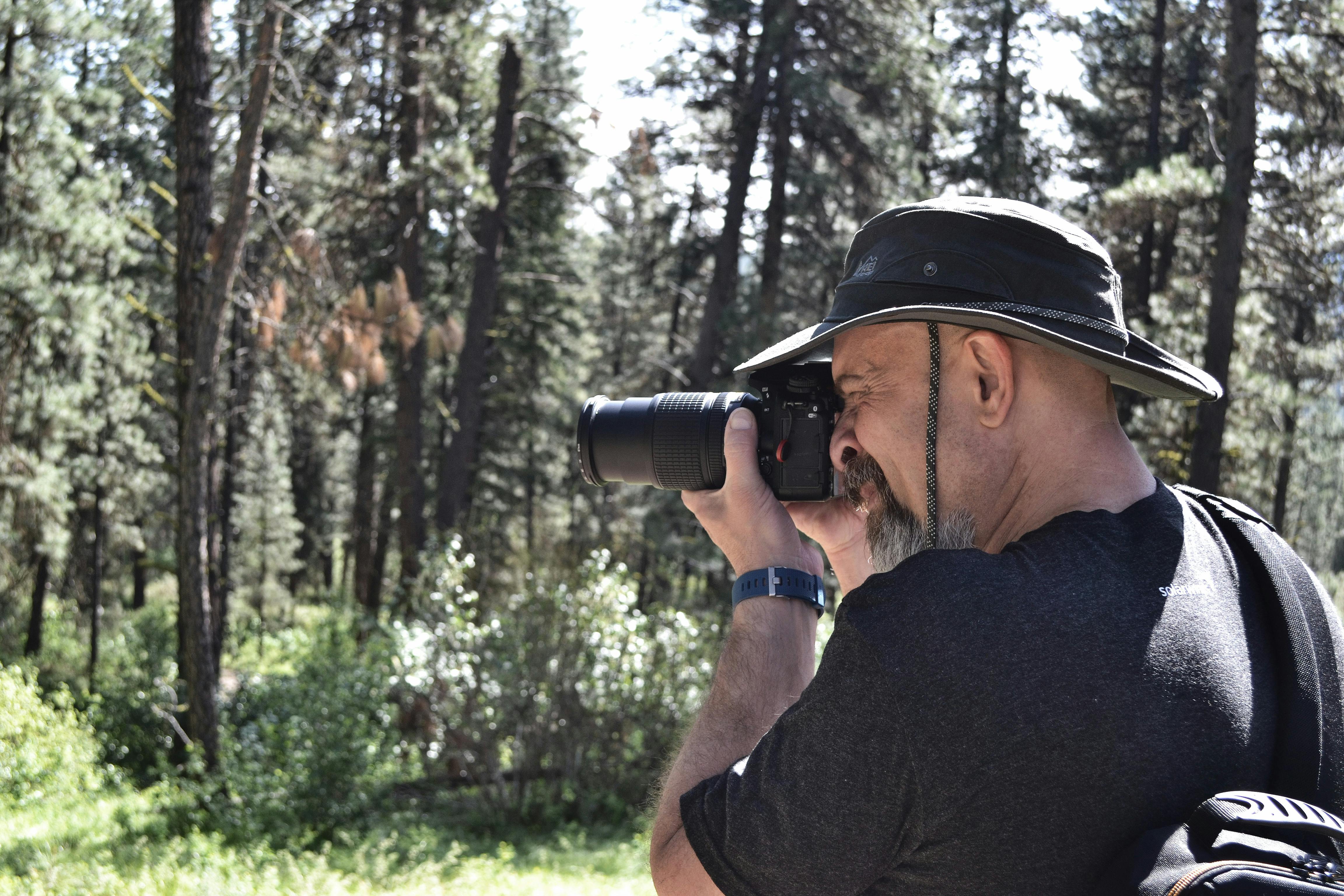 Man Taking Photo in Near Woods