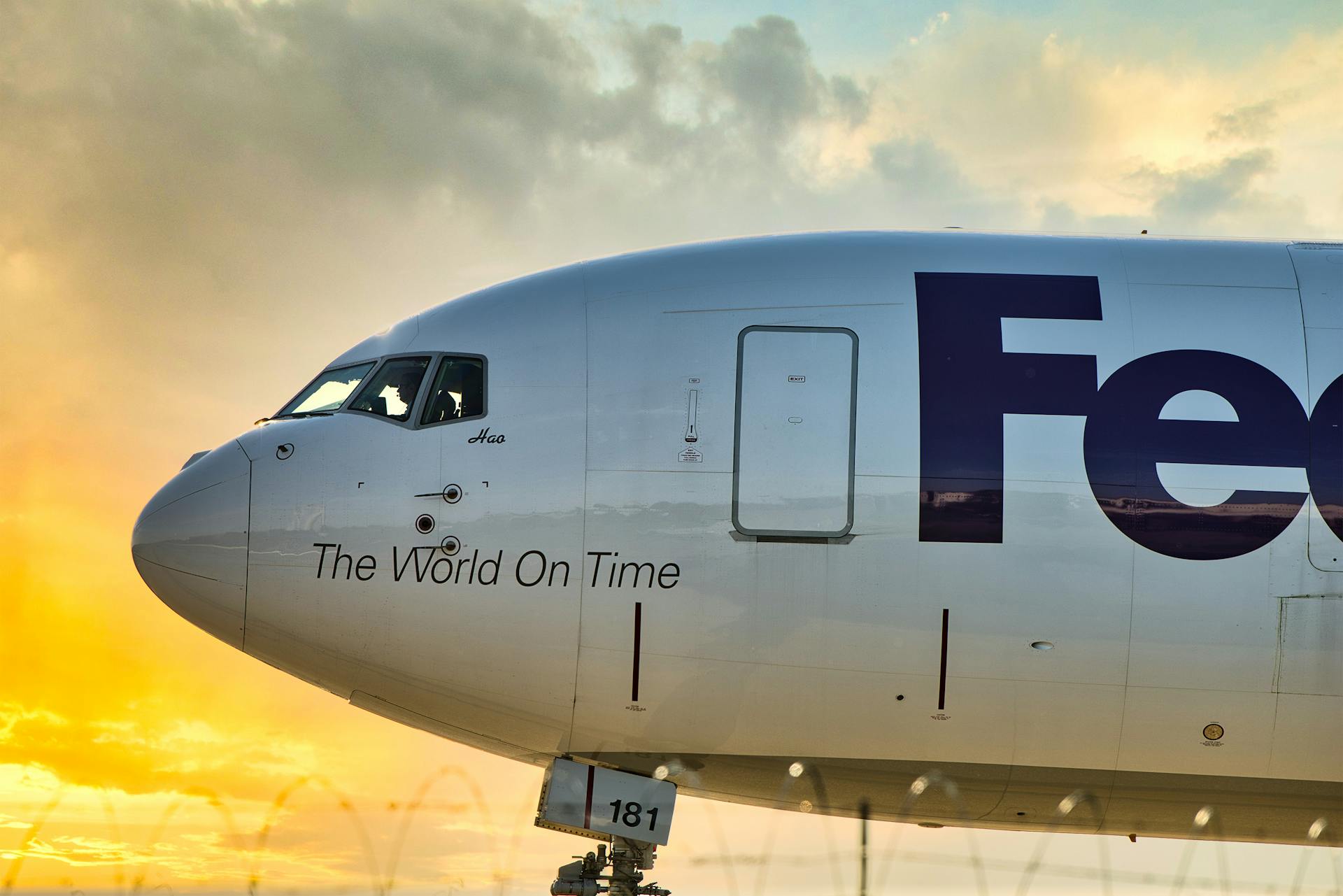 FedEx cargo airplane depicted with vibrant sunset sky at Memphis Airport, showcasing logistics theme.