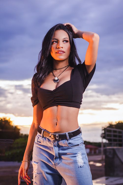 Free A Woman in Black Crop Top and Blue Denim Jeans Stock Photo