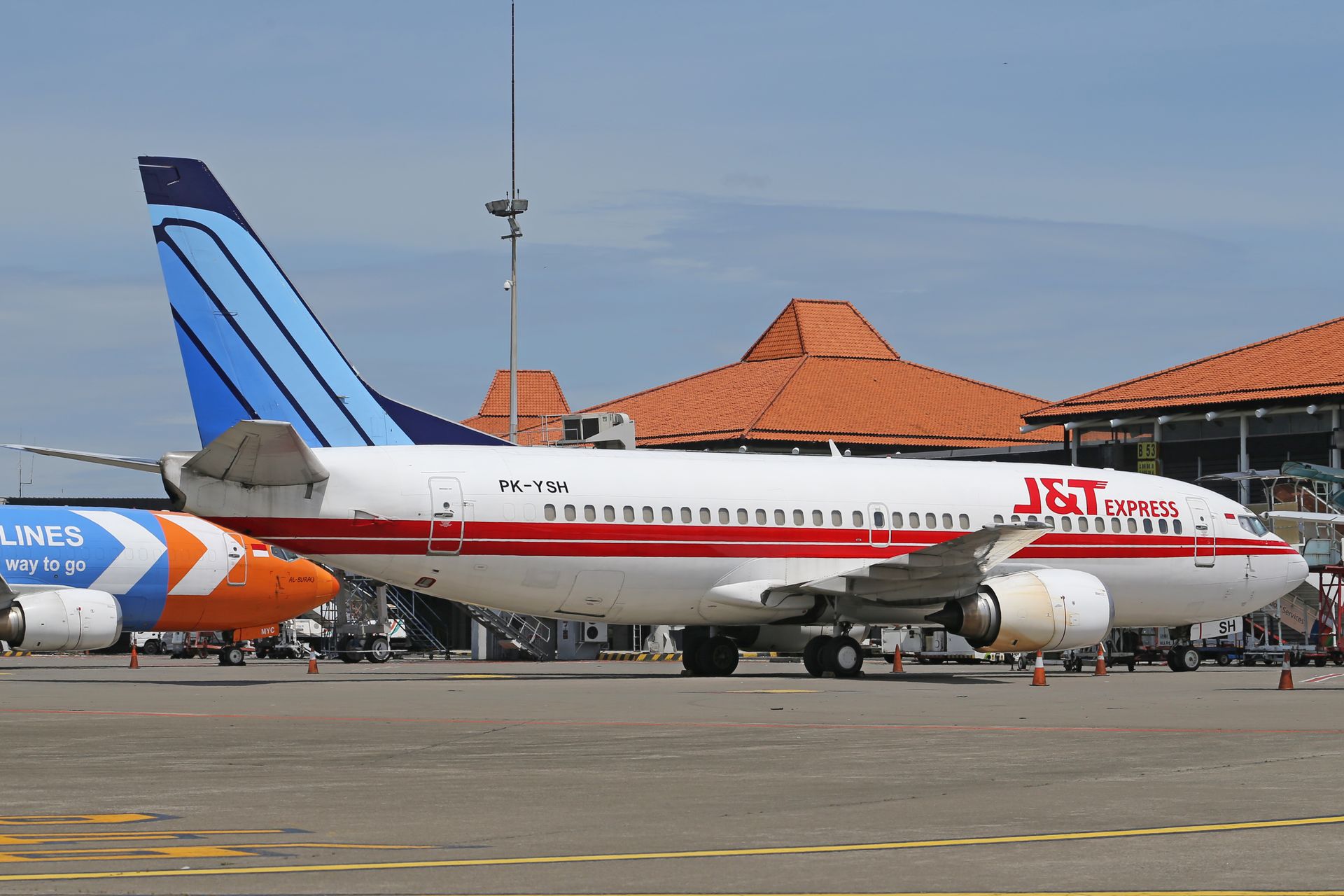 A commercial airplane parked at an airport terminal, ready for boarding.