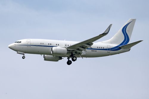 Free A commercial jet airplane flying smoothly through a clear blue sky, showcasing aviation artistry. Stock Photo