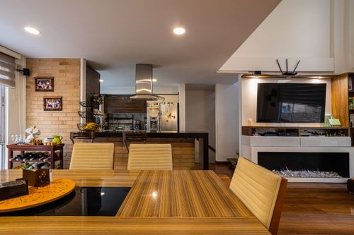 Free Elegant modern dining and living space with wooden accents in Bogotá, Colombia. Stock Photo