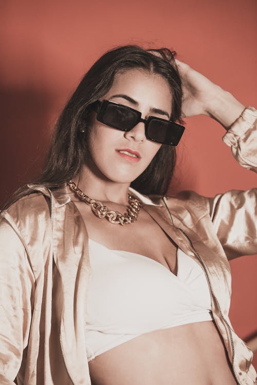 A Woman Wearing Sunglasses Posing at the Camera