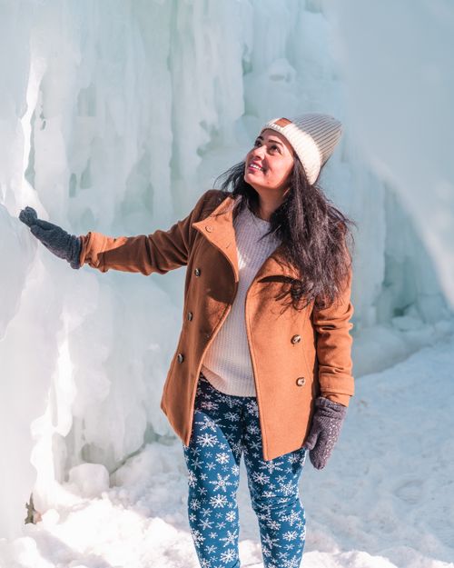 Free Happy woman exploring a stunning icy landscape, embracing winter adventure. Stock Photo