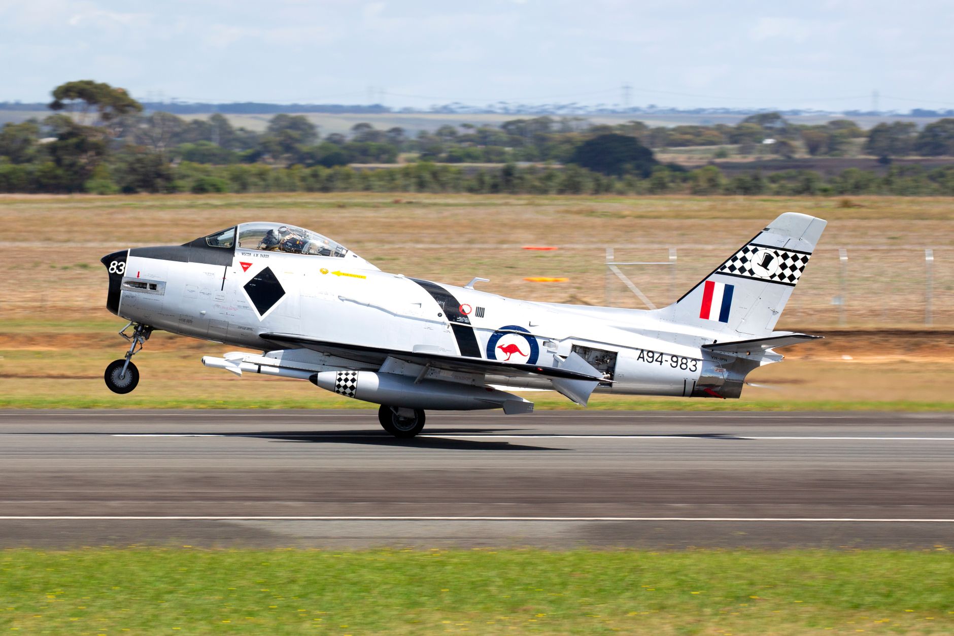Vintage fighter aircraft taking off from tarmac at Avalon Airshow in Lara, Australia.