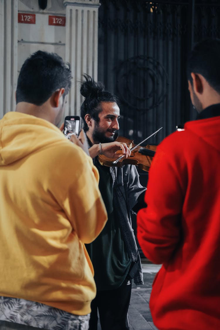 A Man Playing Violin On The Street