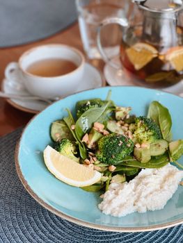 Delicious and nutritious vegetable salad served with a refreshing cup of tea.