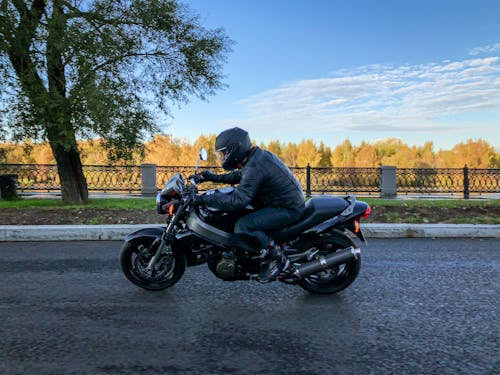 Free A Man in Black Jacket Riding a Black Motorcycle Stock Photo