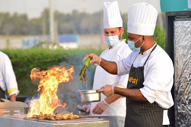 Chefs Cooking At The Grill