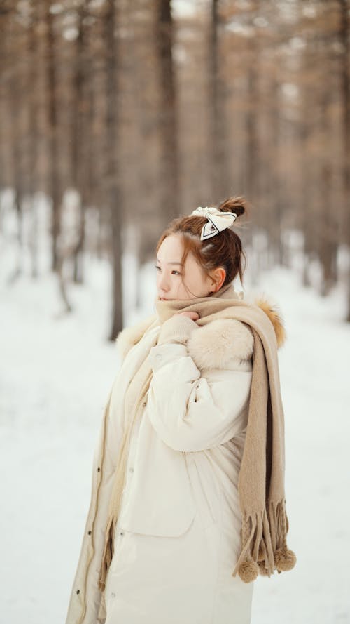 Woman in White Coat in Winter Forest 