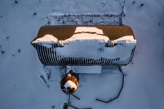 Aerial photograph of a snow-covered barn surrounded by winter landscape in Minnesota.