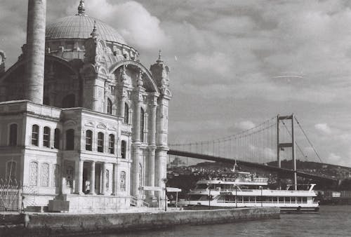 Grayscale Photo of Ortakoy Mosque Near the Bridge