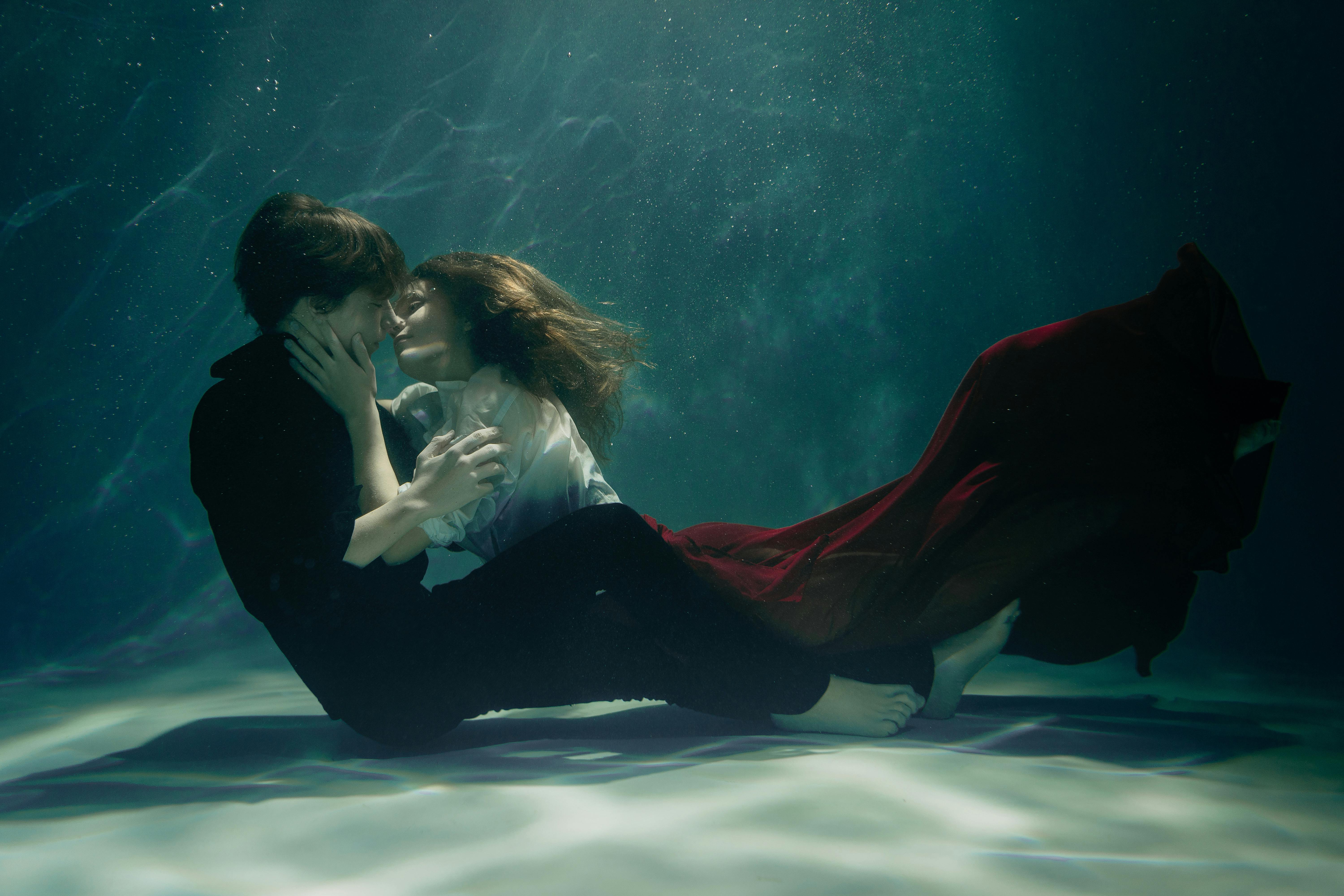 a couple embracing and kissing underwater