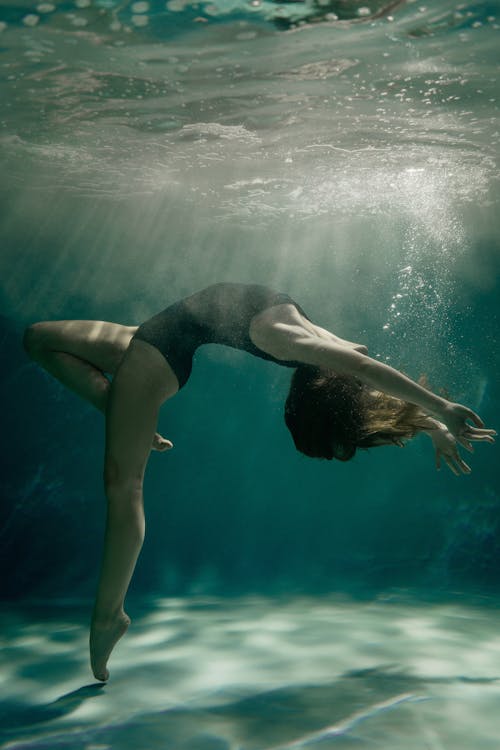 Free Woman in Swimsuit Dancing Underwater  Stock Photo