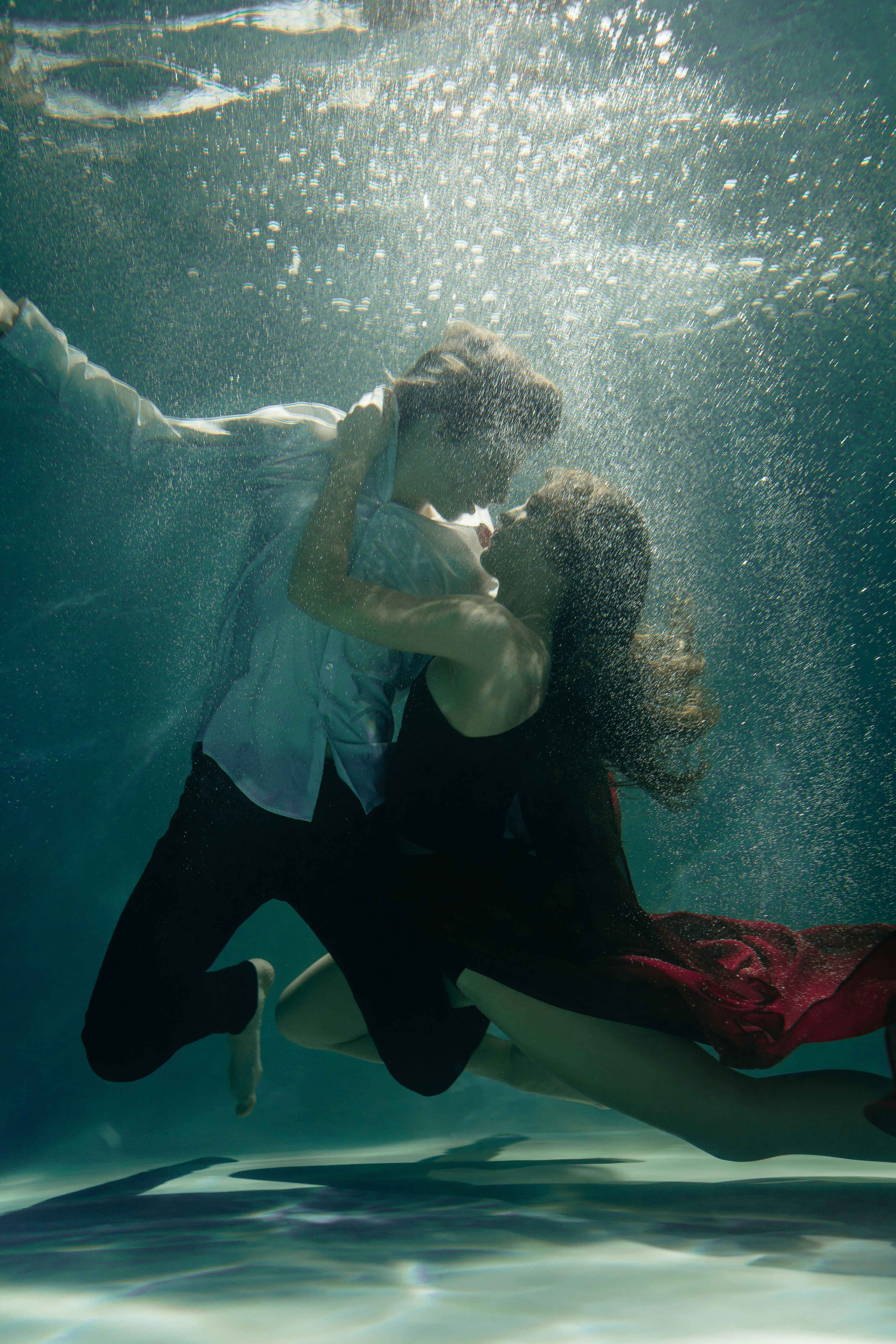 a couple dancing underwater