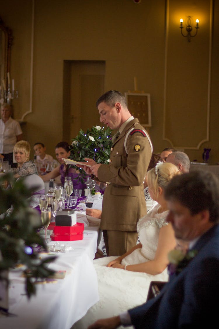 A Military Man In Brown Uniform Reading A Letter 