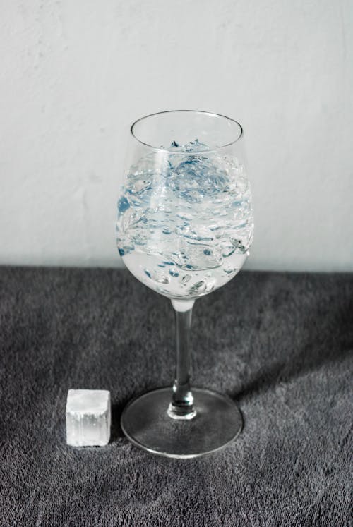 Glass of Drink on Gray Carpet