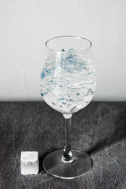 Free A close-up shot of a wine glass filled with ice water, perfect for refreshment. Stock Photo
