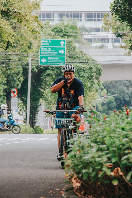 Man Riding a Bicycle on the Street