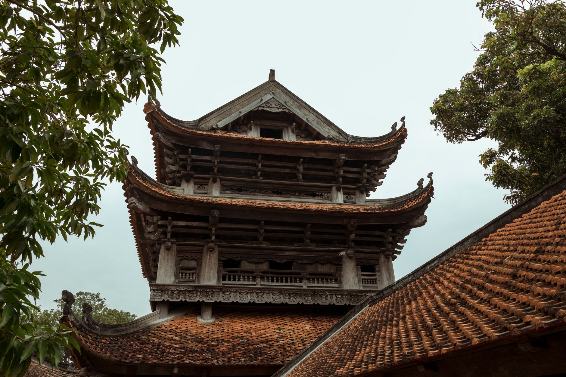 Low angle view of traditional Vietnamese Buddhist temple architecture with ornate roof.