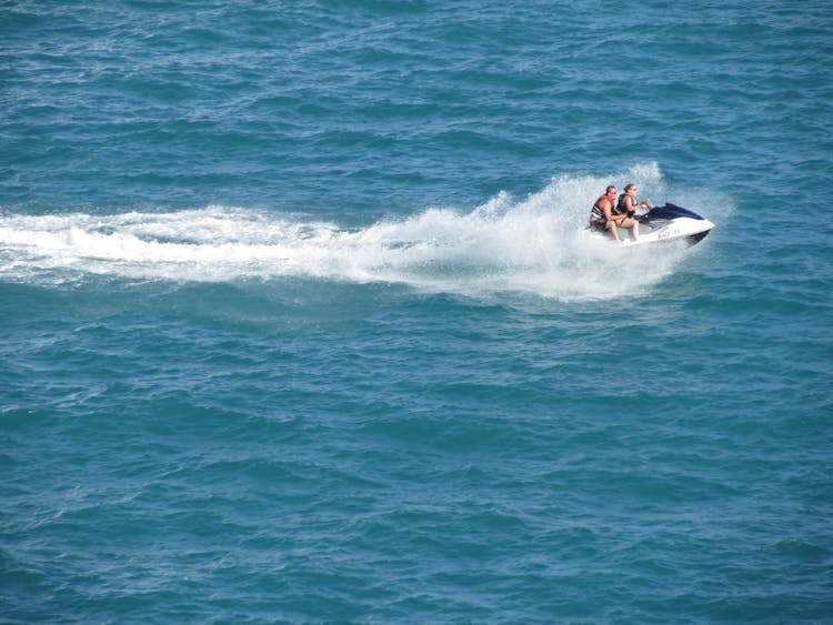 Couple Riding A Jetski