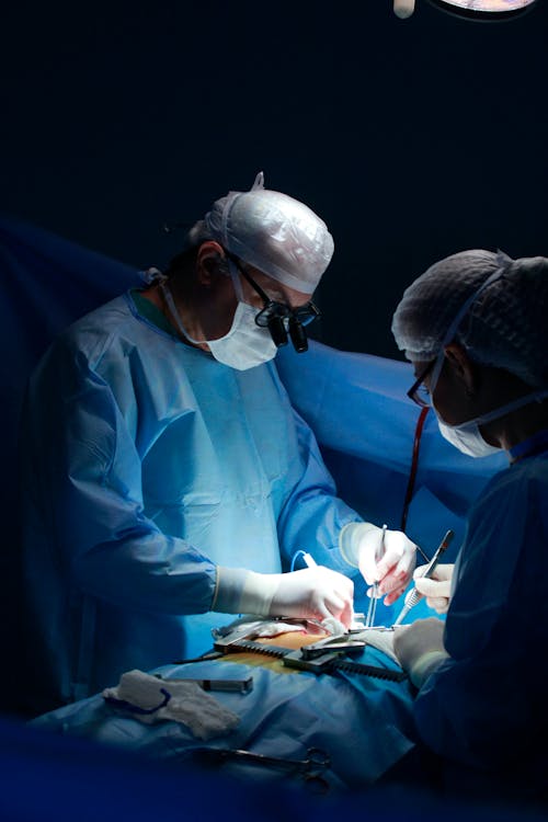 Doctor Wearing Surgical Suit While Operating 