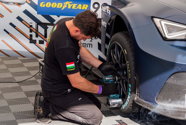 Man Fixing The Tire Of A Car 