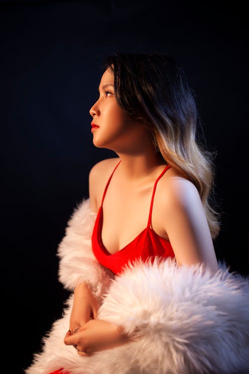 A Beautiful Woman in Red Tank Top with White Fur Coat