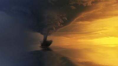 Tornado on body of water during golden hour
