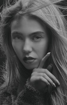 Artistic black and white portrait capturing a woman deep in thought with intense expression.