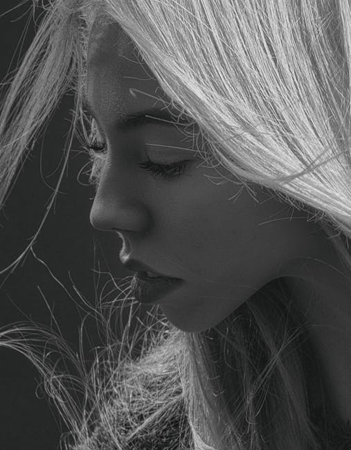 Close-up portrait of a woman in grayscale, highlighting expressive emotions.