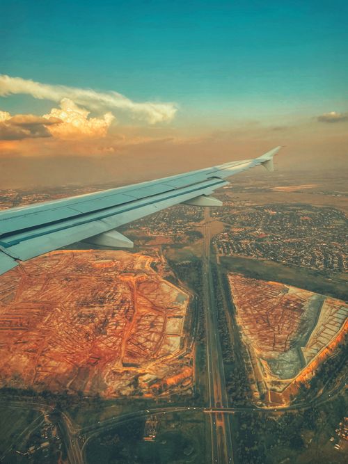 Free A striking aerial view of Johannesburg, capturing urban sprawl and the natural landscape from the airplane window. Stock Photo