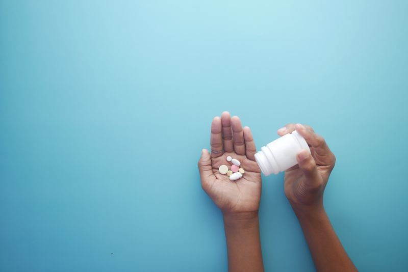Tablets held in an open hand. Knowing what to expect from metformin makes the early side effects easier to manage.